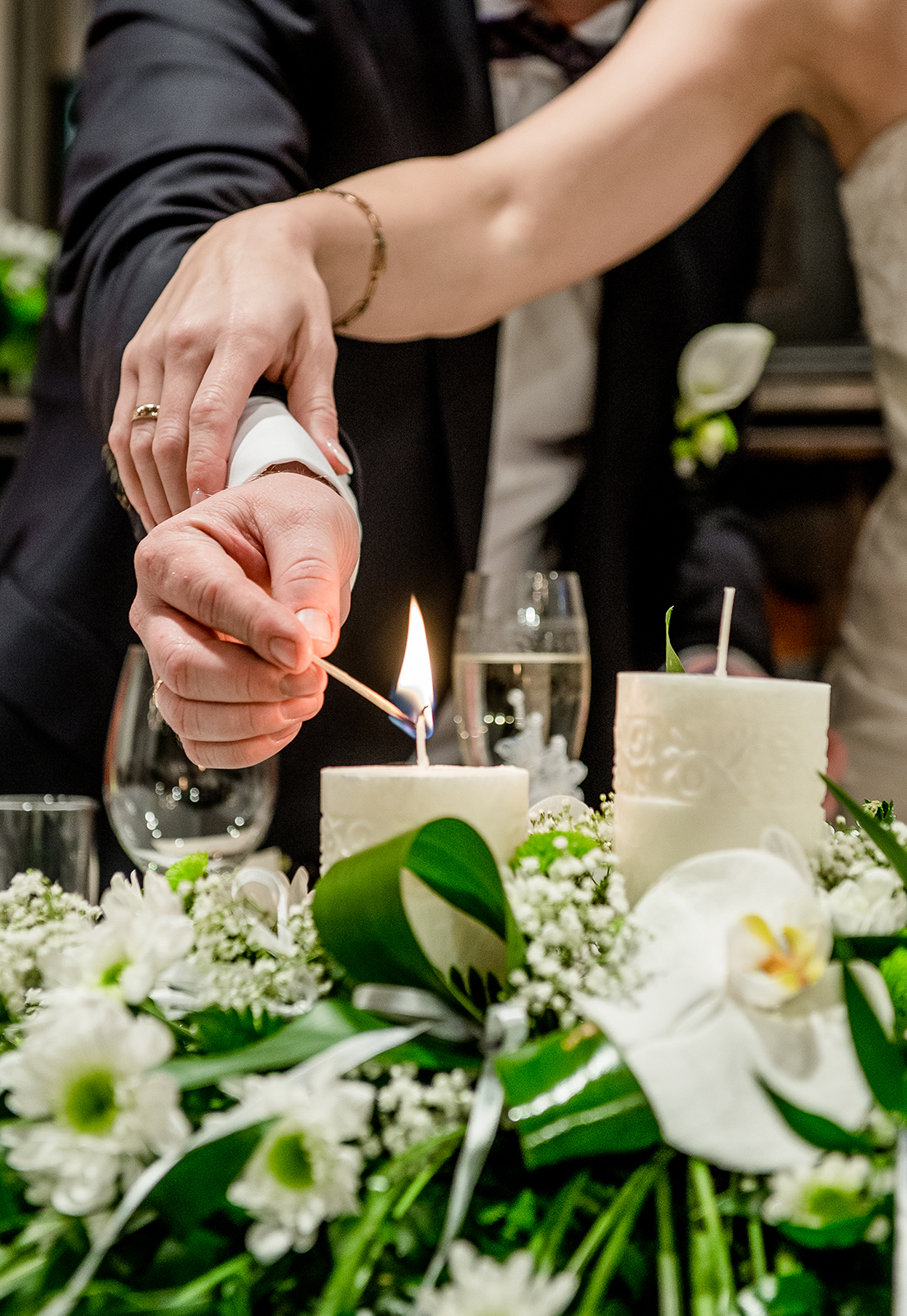 Bride and groom lighting a candle