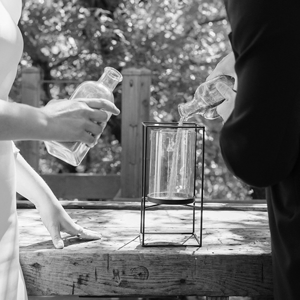 Una pareja realiza el rito de la arena en una boda civil.